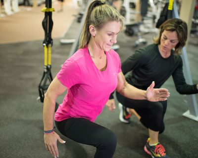 Woman Learning From a Personal Trainer at Colorado Athletic Club - Boulder