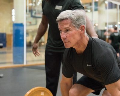 Man Lifting Weights With a Personal Trainer | Colorado Athletic Club - Boulder