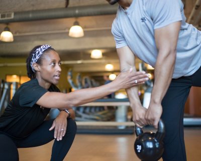 Personal Trainer Coaching Man to Use a Kettlebell | Colorado Athletic Club - DTC
