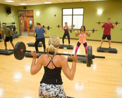 Fitness Class Doing Weighted Squats | Colorado Athletic Club - Flatirons