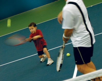 Young Boy Learning Tennis From an Instructor | Colorado Athletic Club - Flatirons