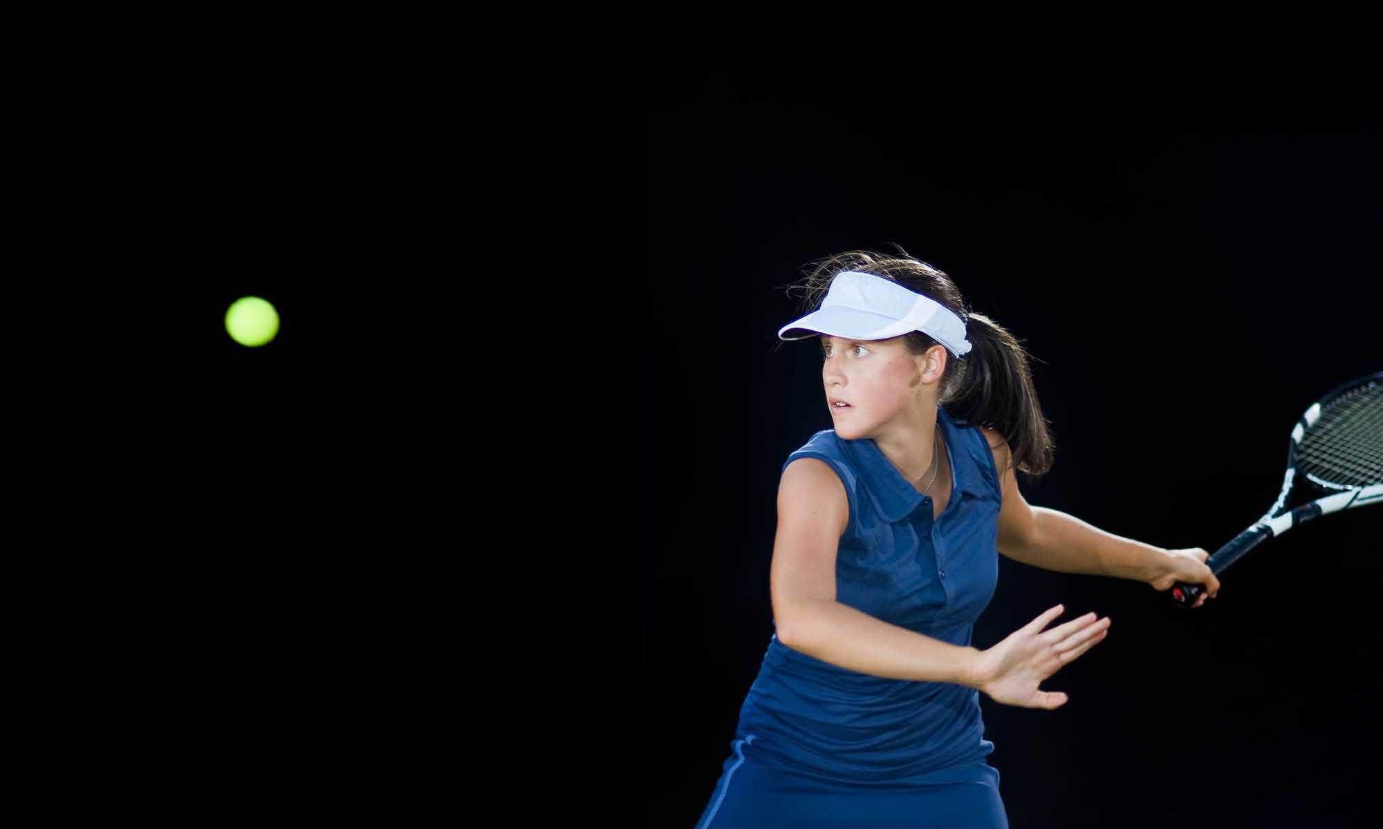 A girl competing in the junior tennis program at Colorado Athletic Club