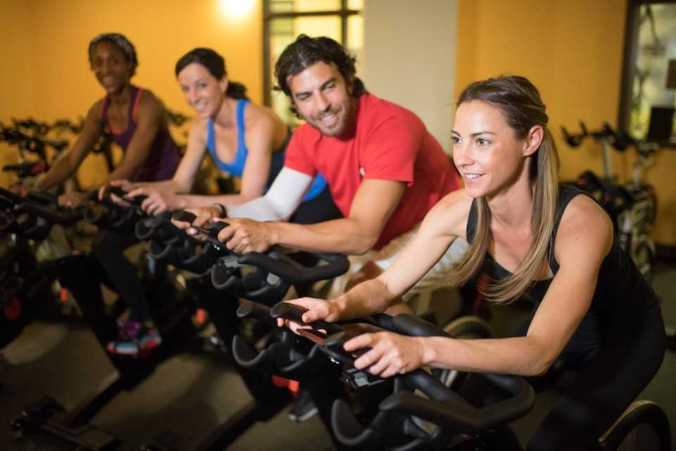 A group of people indoor cycling at Colorado Athletic Club