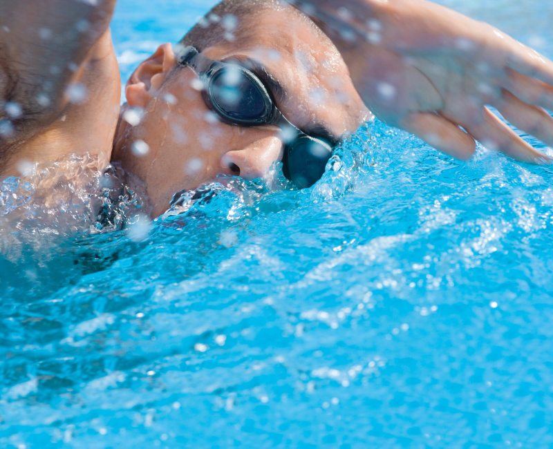 Man swimming at Sports & Wellness Midtown at Wellbridge