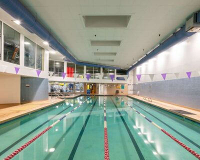 Indoor swimming pool featuring a long design and a blue wall in the background in Albuquerque, NM