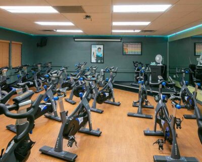 A Wellbridge gym featuring exercise bikes and large mirrors in Albuquerque, NM