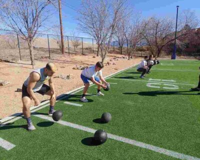 A group of people training on a field engaged in sports training in Albuquerque, NM