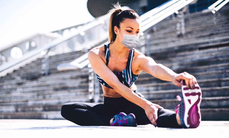 Woman doing stretches with safety mask,CO