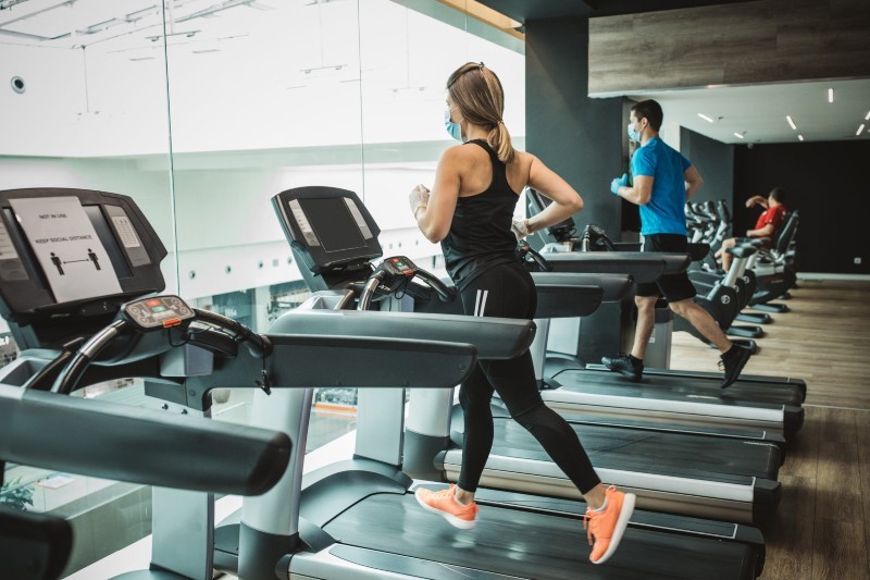 Woman running on treadmill at Wellbridge