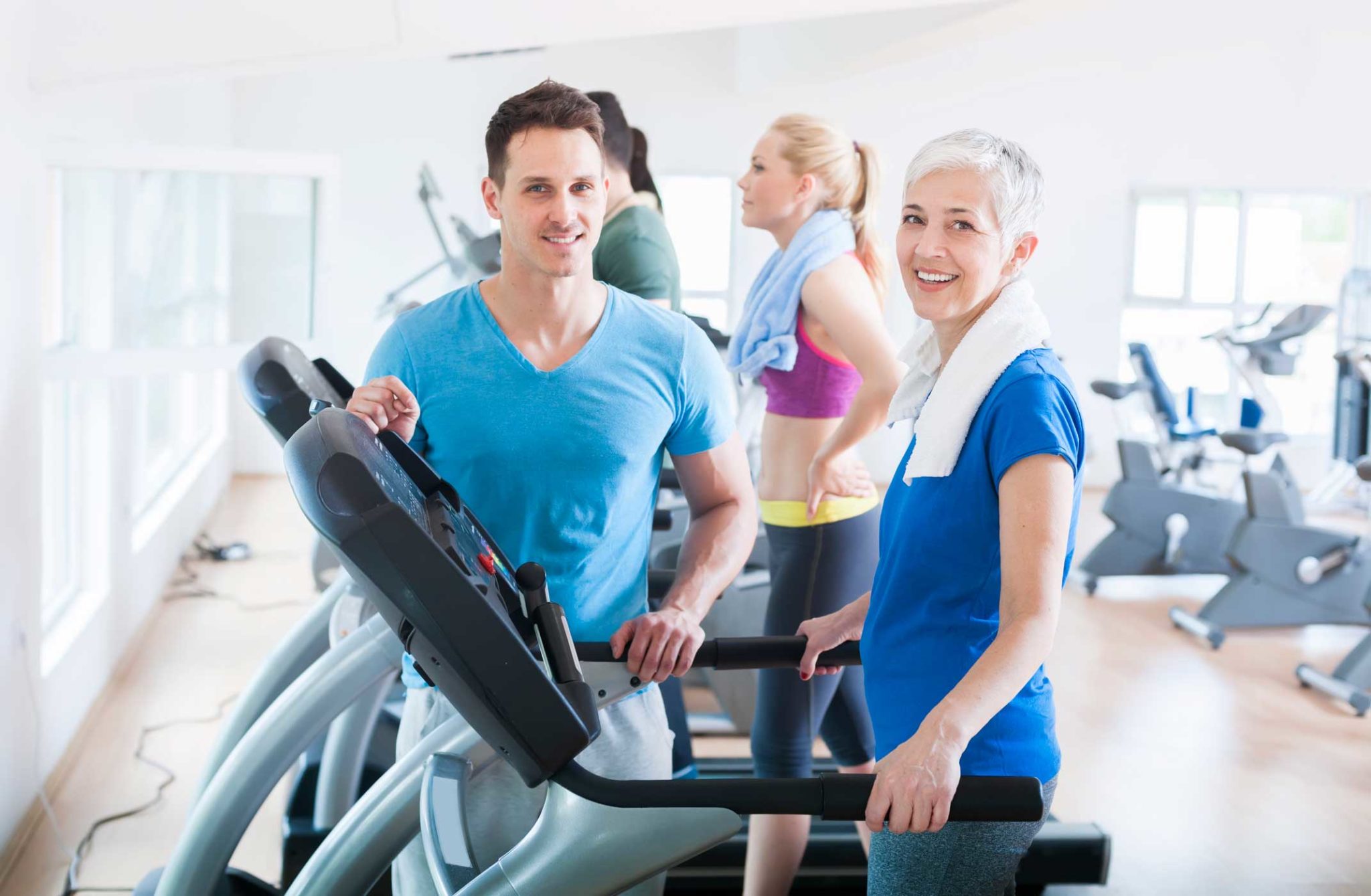 lady on treadmill with personal trainer